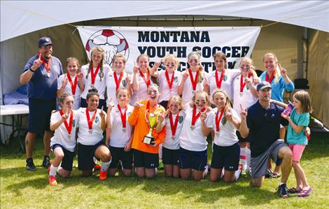 The Polson FC U14 team celebrates adter winning the State Cup.