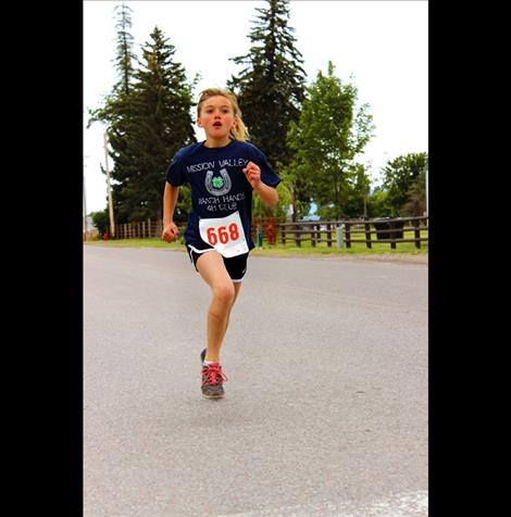 Megan Evelo, 12, finishes the 4-H Fun Run in first place.