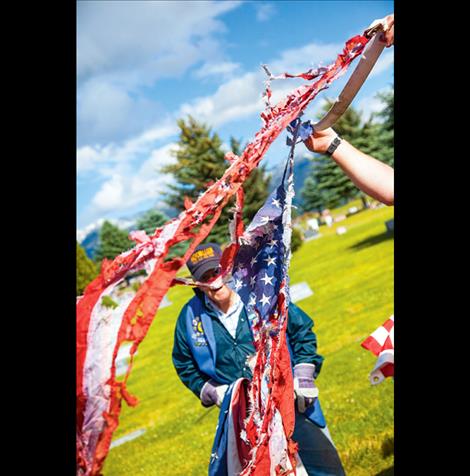 A tattered flag is retired.