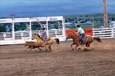 Jimmy Racine and Pete White compete in team roping.