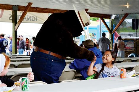 Smokey Bear and Jordann Underwood, 10, take a moment for a fist bump.