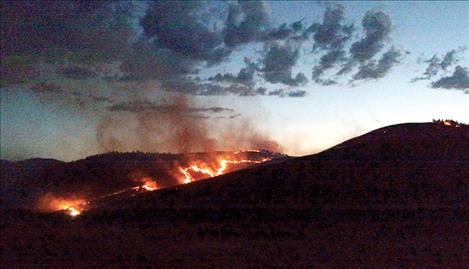 A fire burns over Ravalli Hill the evening of Thursday, June 30.
