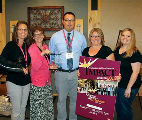 sion School District staff accepts one of the many awards they received this summer.