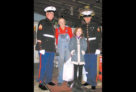 Marines Chuck Lewis, Mike Dennison and Dennison’s daughter Allison deliver toys to a Lake County family Dec. 20.