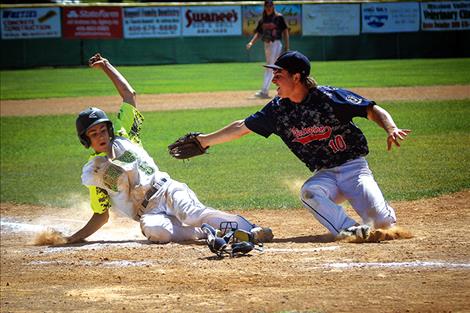 Mariner Bryant Hales slides into home during the championship game against Livingston.