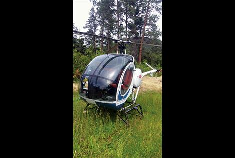 A commercial pilot safely landed a helicopter he was piloting Saturday afternoon in the Yellow Bay area. No one was injured but the aircraft suffered damage to the transmission and rotors.