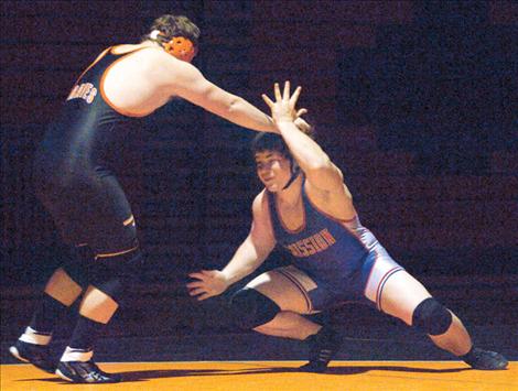 Mission senior Barret Sargent evades the grasp of a Flathead grappler.