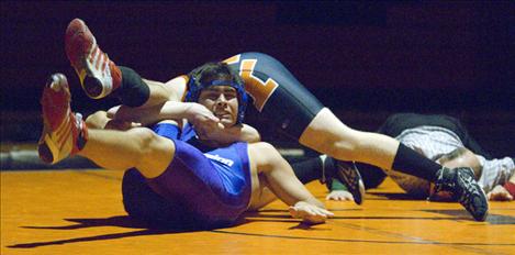 Joseph Hawkins struggles to break free from a Flathead wrestler.