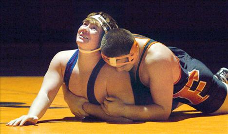 Tyler Spidel, above, tangles with a Flathead opponent in the 285-pound class during a Dec. 11 dual in Ronan.