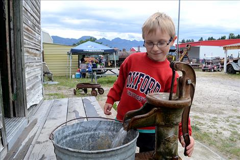 Max McLeod, 6, pumps water at the museum.