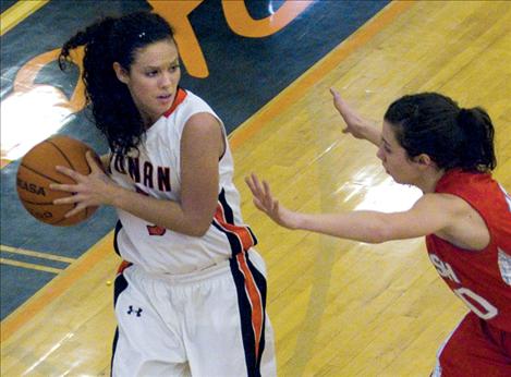 Kendra Starkel looks for help from a teammate as a Loyola defender closes in.