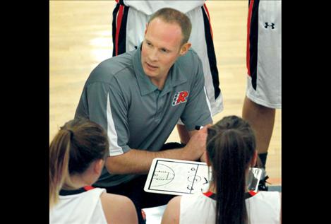Maidens head coach Clayton Curley talks strategy with his team during Ronan’s Dec. 18 game against Loyola.