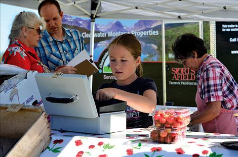 Aubrey  Sharbono,  10,  takes a shift  at the  cherry  stand;  the  project  benefits   the Boys  and  Girls Club. 