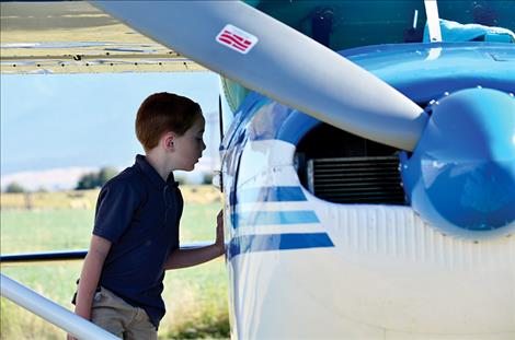 Jason Leishman, 7, peers into the cab of one of the airplanes. 