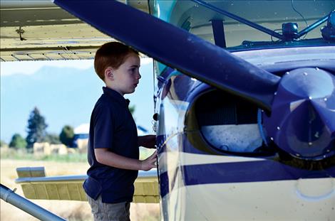 Jason Leishman, 7, peers into the cab of one of the airplanes. 