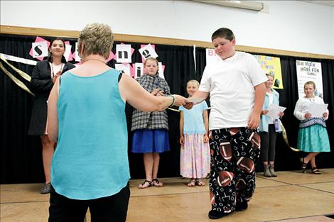 The only male contestant in the Lake County Fair sewing competition shows off his football pants.