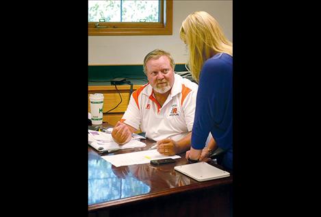 Mark Johnston, interim superintendent for Ronan School District, discusses the district budget with assistant Jennifer Cheff.