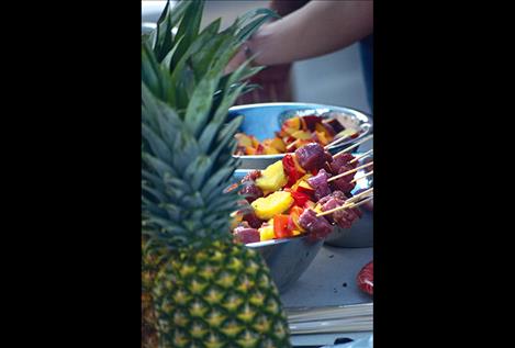 Skewers of pork, pineapple, pepper and peaches await the barbecue at the Holy Smokes booth.