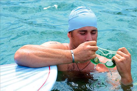 A swimmer prepares goggles before the race.