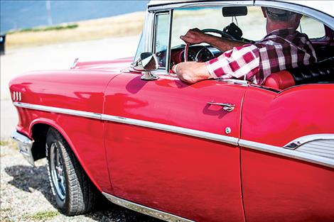 un, relaxes in the 1957 Chevy he has had since high school.