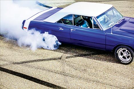 A 1972 Dodge Dart burns rubber at the racetrack.