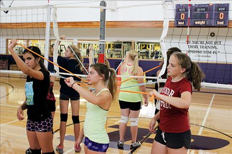 Lady Pirate volleyball team members do arm strengthening exercises.