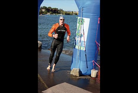 Matthew Friz finishes his leg of the triathlon and stats that he found swimming in the current of Flathead River a lot harder than swimming in a pool.