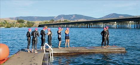 Female participants in Saturday’s Triathlon Race prepare for the 1.5 mile open water swim.