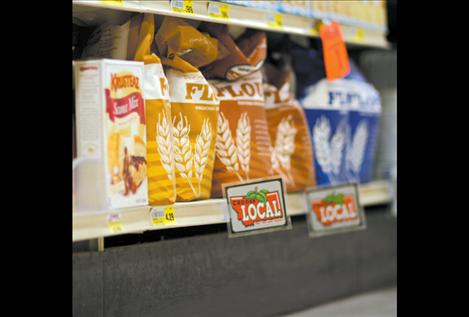 Signs that read, “Choose Local: Fresh from your neighbor” identify locally produced goods on Harvest Foods’ shelves.