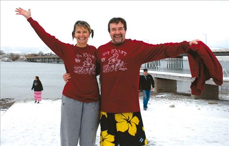 Connie and Dave Bull sport their “dip shirts.” “Can’t buy it, gotta earn it,” the shirt says, which means a person needs to jump into Flathead Lake on New Year’s Day. The Bull family began the polar plunge tradition in Polson.