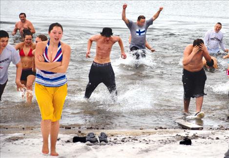 Polar plungers rush out of Flathead Lake on Jan. 1. With an outside temperature of about 28 degrees Fahrenheit, resident expert Dave Bull said the lake water was between 32 and 40 degrees. 