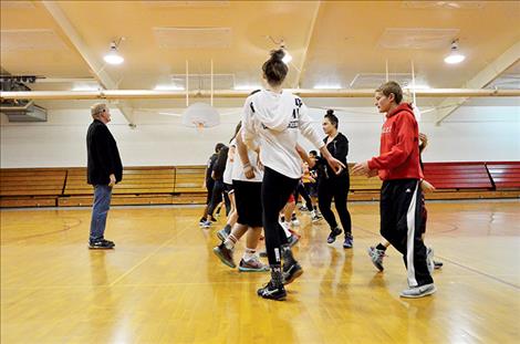 Students practice contra dancing while instructor Mark Matthews calls out instructions.