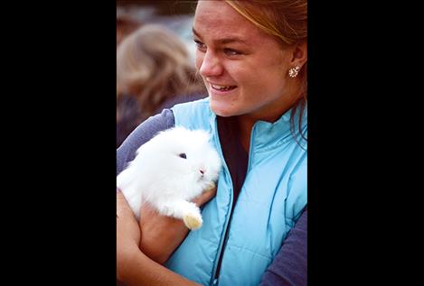 Devi Knutson holds one of the Saddle Mountain 4-H bunnies at the petting zoo