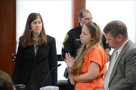 Kassandra Seese, center, takes the oath before changing her plea to guilty to accountability in the February death of 18-year-old Richard Warner.