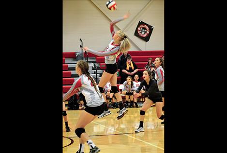 Carly Hergett leaps for one of her six kills against Plains on Sept. 20.