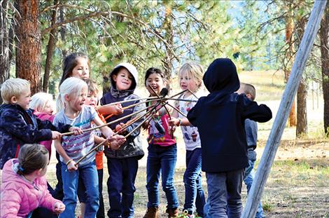 Kids play traditional games at one of the stations.