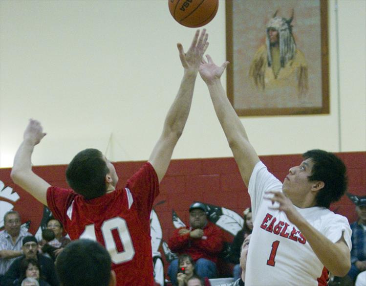 Blaine Leonard stretches to beat Arlee's Josh Reed at tip-off. 