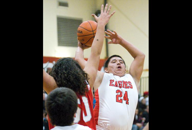 Two Eagle River’s Clayton Malatare goes up for two Saturday during the Eagles’ game against Arlee, which the Warriors won, 107-68. 