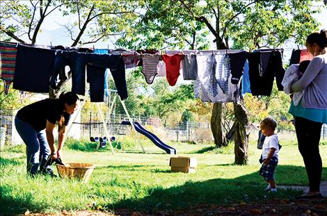 lie Lowther hangs laundry at The Nest. She is working on building a healthy life for her children with support from staff including Resident Advocate Amy Tall Bull.
