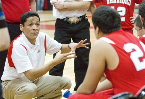 Head coach JR Camel, a former  University of Montana Grizzly basketball player, talks strategy with the Warriors during a timeout in Saturday’s game.