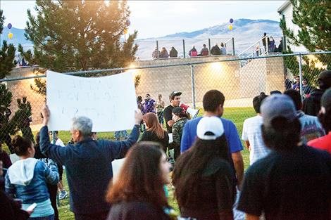 Dustin Monroe speaks to a crowd outside the Polson High School football stadium.