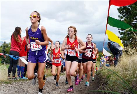 Lady Pirate Molly Sitter, running in Missoula, above, broke below the 20-minute barrier Saturday in Whitefish.