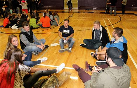 Groups huddle to discuss the Bible and pray for each other.