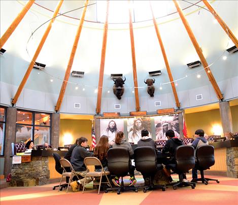 Students sit down in front of the tribal council.