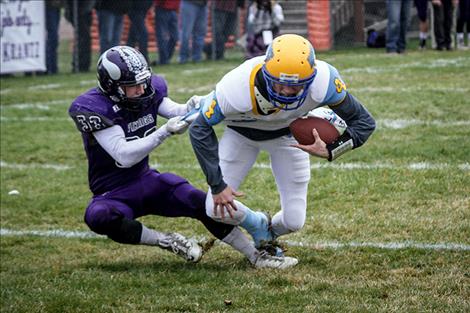 Toby Odom (33) tackling Hawks quarterback for a safety.