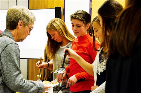 Students serve the public food they grew and cooked.