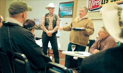 Tucker Hughes, center, president of the Montana Stockgrowers Association, and Gene Curry, first vice-president, left, talk to the Western Montana Stockgrowers Association about legislation as WMSA president Ken McAlpin looks 