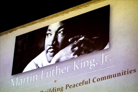 A projected banner with Dr. Martin Luther King Jr.’s picture hangs above the crowd and panelists as the discussion began.