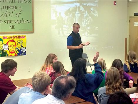 Chief Warrant Officer Brian Piercy shares a slide show presentation with MVCA students.