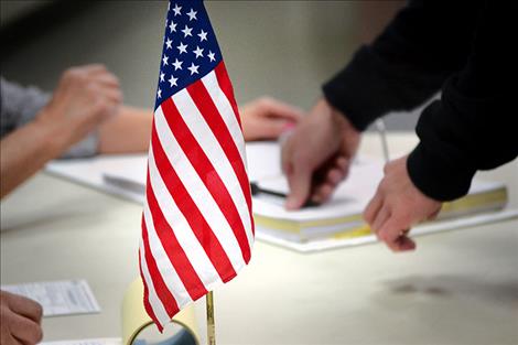 A voter signs in at his polling place in Ronan Nov. 8.